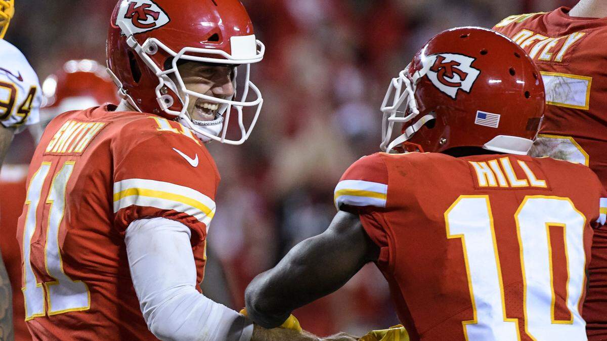 Kansas City Chiefs quarterback Alex Smith (11) celebrates his touchdown with wide receiver Tyreek Hill (10) during the second half of their NFL football game in Kansas City, Mo., Monday, October 2, 2017. (AP Photo/Reed Hoffmann)