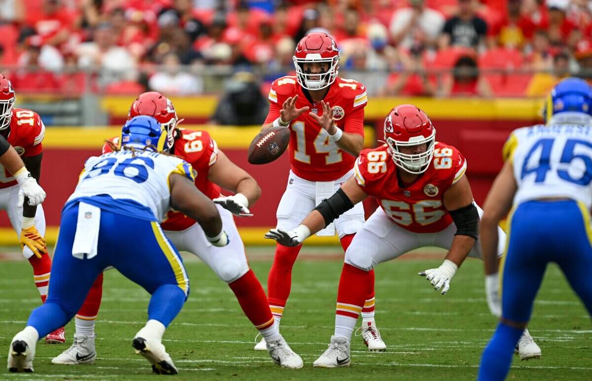 Kansas City Chiefs offensive lineman Hunter Nourzad (64) snaps the ball to Chiefs quarterback Garrett Nussmeier (14) in the second quarter of the Kansas City Chiefs vs. Los Angeles Rams preseason game at Arrowhead Stadium in Kansas City on Aug. 15, 2026.