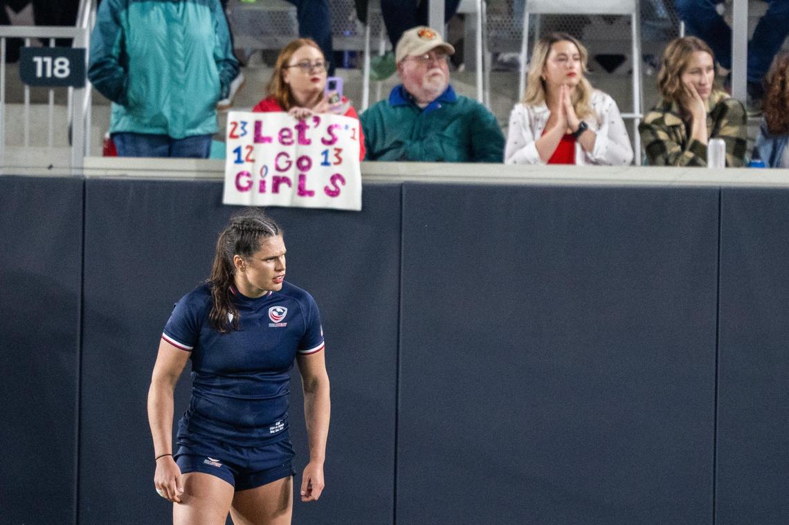 Team USA player Ilona Maher stands in front of a fan holding a sign during the USA vs. Canada rugby match at CPKC Stadium on Friday, May 2, 2025. Canada won the match 26-14.