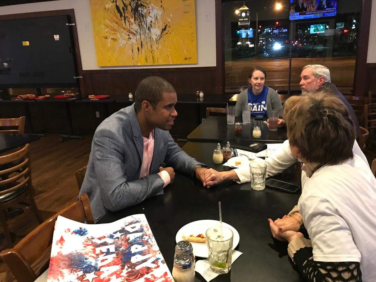 Rucker, left, meets with supporters on election day.