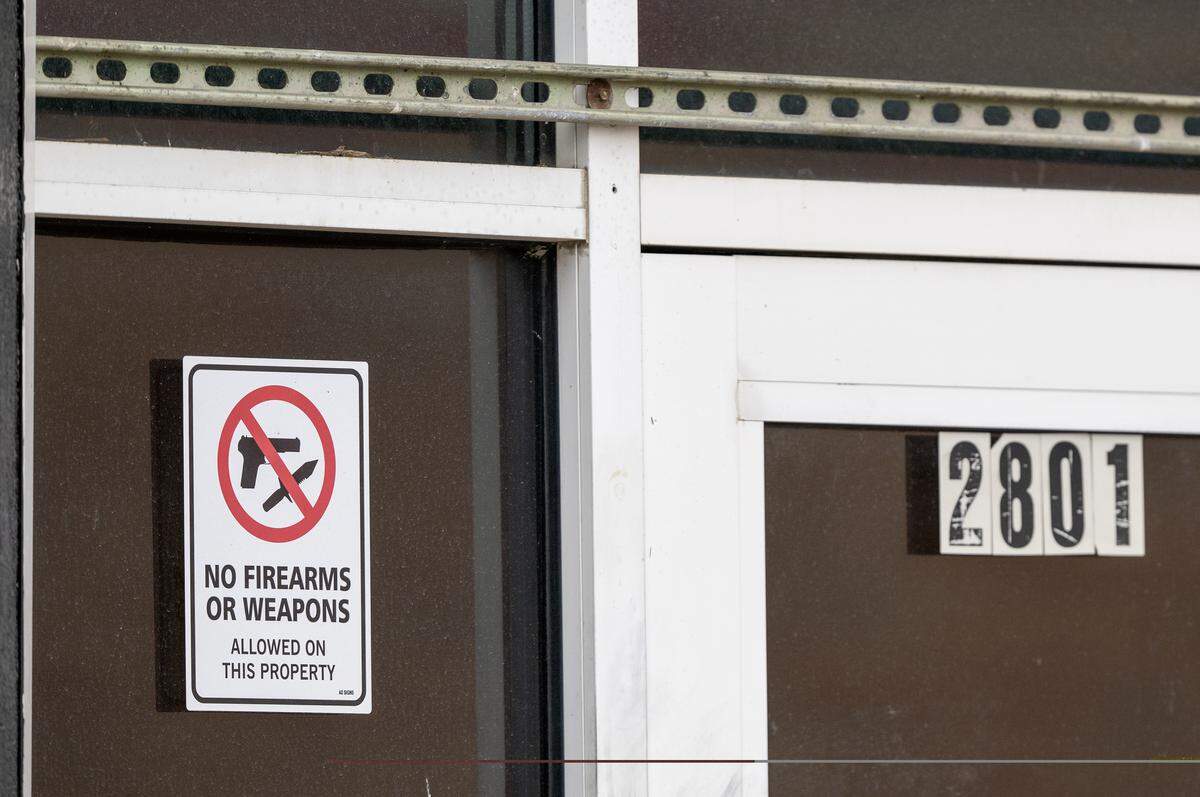 Signs denoting ‘No Firearms or Weapons’ are posted at Status nightclub, 2801 Southwest Blvd., on Monday, Feb. 16, 2026, in Kansas City. Two women were fatally shot and two other people were injured in a shooting at the night club on Sunday, Feb. 15, 2026.