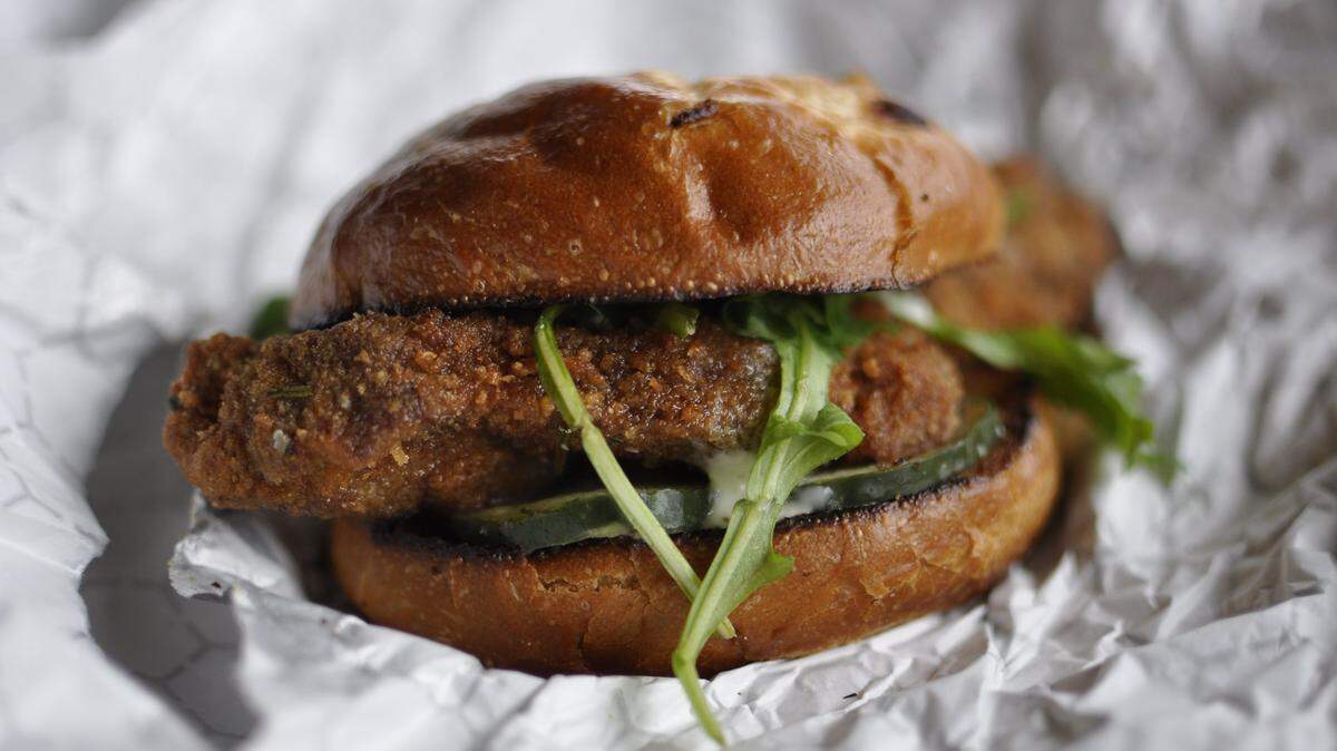 At Pigwich, The Local Pig's sandwich truck, pork tenderloins are topped with arugula and homemade pickle.