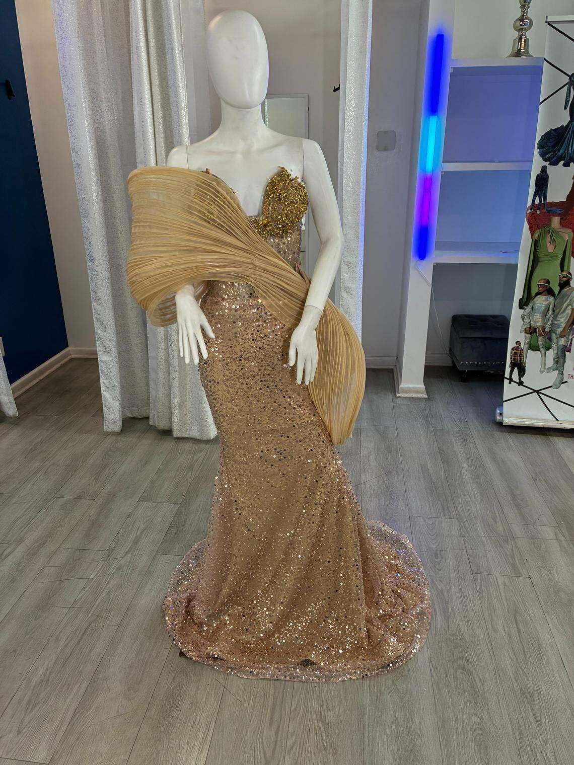 A glamorous champagne-toned gown adorned with shimmering sequins and golden beadwork for added sparkle created by Sheraz Pompey.