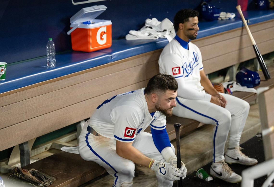 Kansas City Royals outfielder Kyle Isbel (28) and outfielder MJ Melendez (1) sit in the dugout as the Yankees celebrate at 3-1 victory during Game 4 of the American League Division Series on Thursday, Oct. 10, 2024, at Kauffman Stadium.