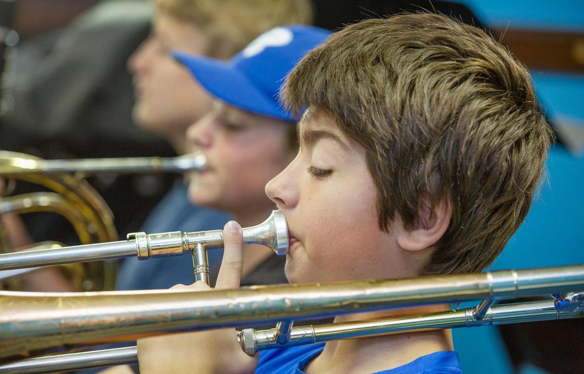 Evan Otto, 14 played his trombone during a practice session for the A-Flat Youth Orchestra Saturday, May 31, at Jamison Memorial Temple CME Church in Kansas City.