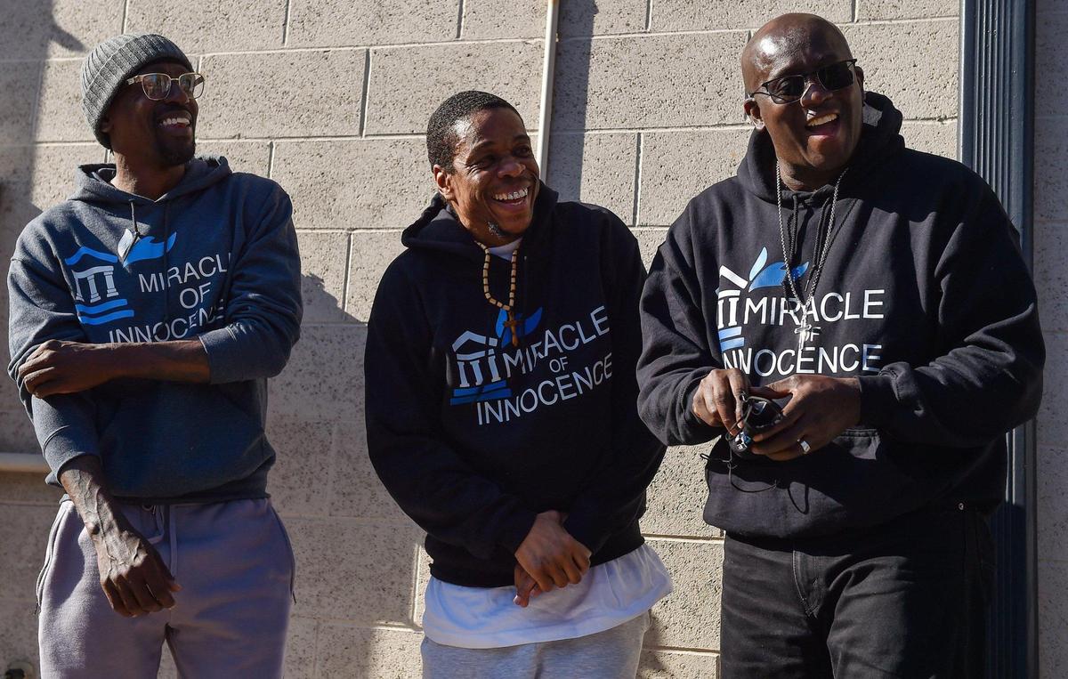 Miracle of Innocence co-founders Lamonte McIntyre, left, and Darryl Burton, right, joined Keith Carnes and shared a light moment during a press conference at Carnes’ attorney’s office Monday, April 11, 2022. Earlier in the day, Carnes was freed from prison after 18 years. The prosecutor’s office declined to file charges after the Missouri Supreme Court threw out his conviction for murder and armed criminal action. All three men are exonerees.
