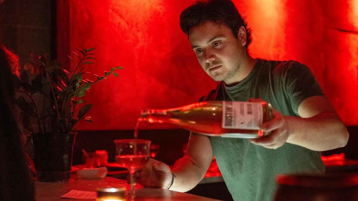 Bartnder Rogelio Zavala refills a guest’s glass of Wonderwerk Bustin’ Loose Rosé during the soft opening of In the Lowest Ferns on Thursday.