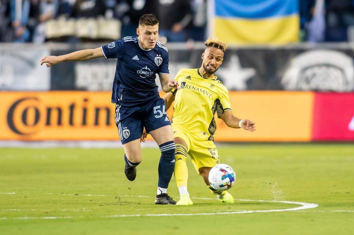 Sporting Kansas City midfielder Rémi Walter powers past Nashville SC midfielder Hany Mukhtar Saturday evening at Children’s Mercy Park in Kansas City, Kan.