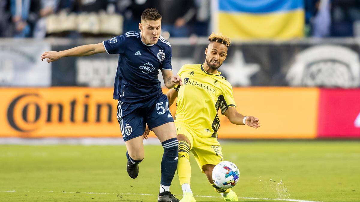Sporting Kansas City midfielder Rémi Walter powers past Nashville SC midfielder Hany Mukhtar Saturday evening at Children’s Mercy Park in Kansas City, Kan.