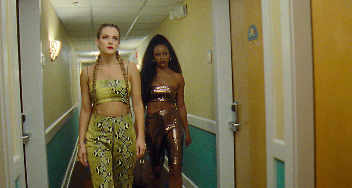 This image released by A24 shows Riley Keough, left, and Taylour Paige in a scene from “Zola.” (A24 Films via AP)