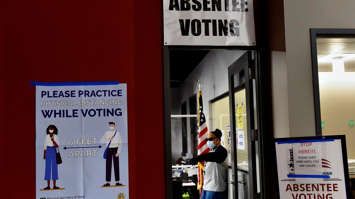 Election judge Craig Hampton stands by to assist voters during voting for the June 2 municipal election in Kansas City.