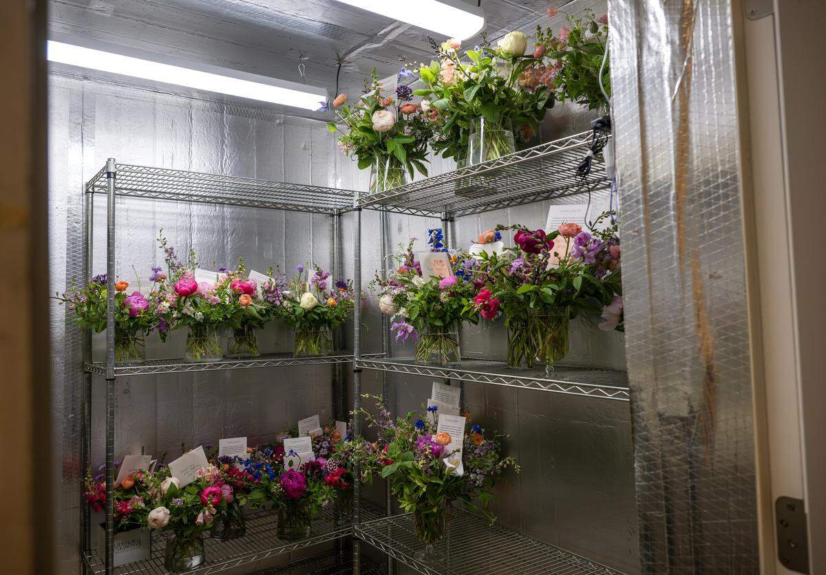 Several bouquet of flowers are stored in a cooler at Lily Floral Collective on Friday, May 8, 2026, in Kansas City.
