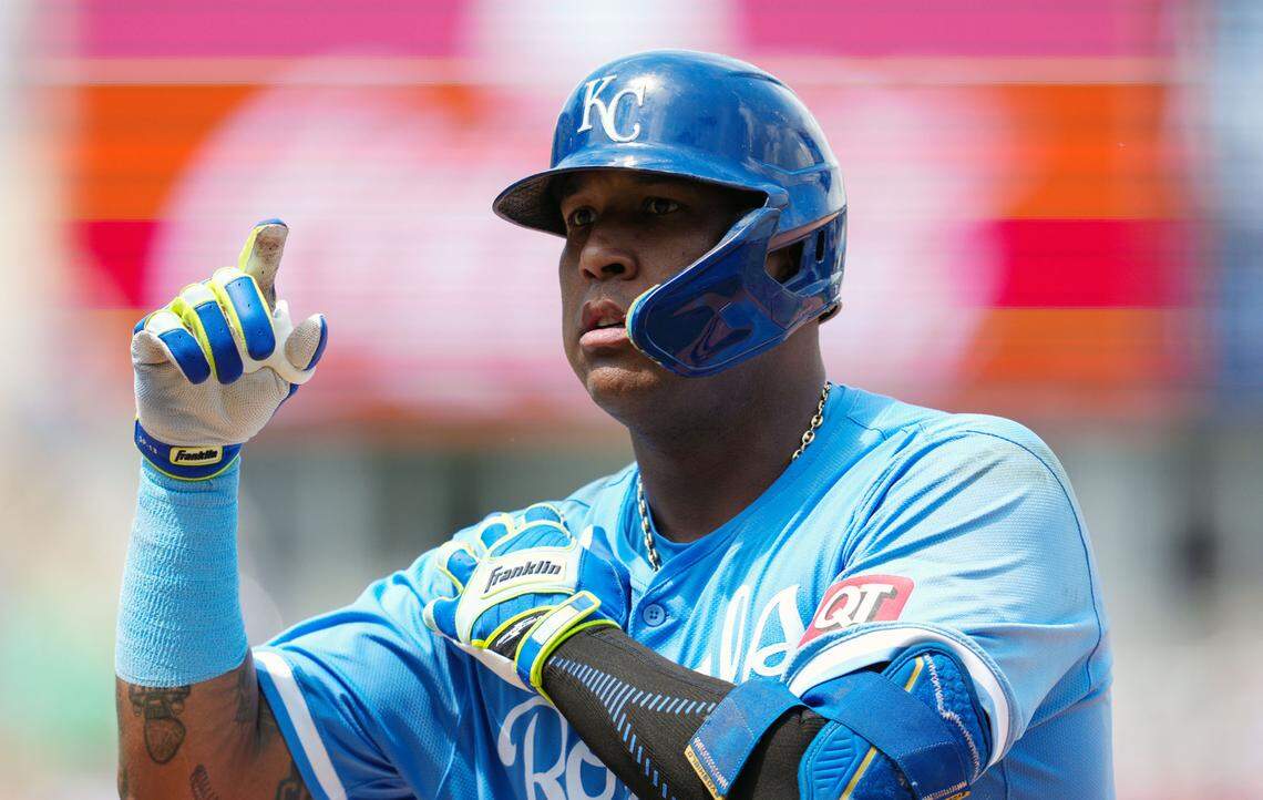Kansas City Royals first baseman Salvador Perez (13) gestures to the dugout after hitting a single during the fifth inning against the Oakland Athletics at Kauffman Stadium.