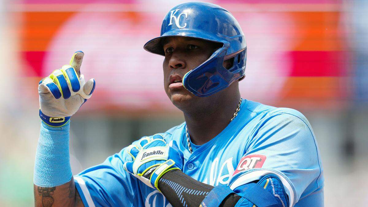 Kansas City Royals first baseman Salvador Perez (13) gestures to the dugout after hitting a single during the fifth inning against the Oakland Athletics at Kauffman Stadium.