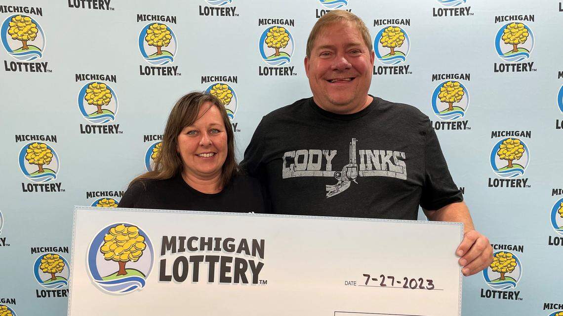 Kristin Murawski, and her husband, Scott, with their oversized check.