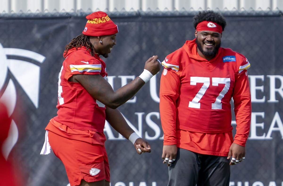 Chiefs offensive lineman Wanya Morris (No. 64) shares a laugh with fellow tackle Jaylon Moore (77) during practice at the team's training facility on Wednesday, Oct. 15, 2025 in Kansas City.