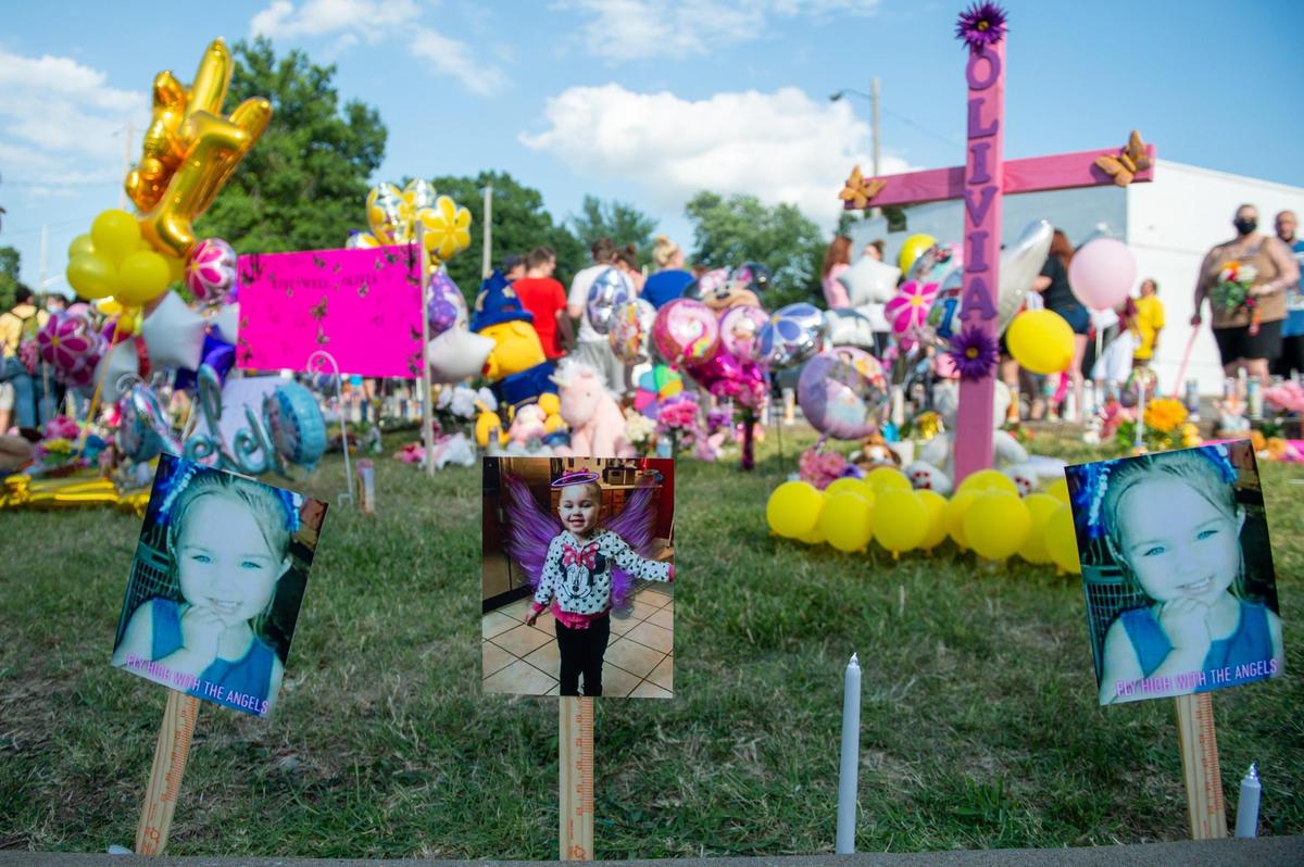 Photos of three-year-old Olivia Jansen graced a makeshift memorial at the corner of 34th Street and Steele Road in Kansas City, Kansas. A crowd of at least 100 people gathered Saturday, July 11, 2020, for a vigil honoring Olivia, who was found dead a day earlier.