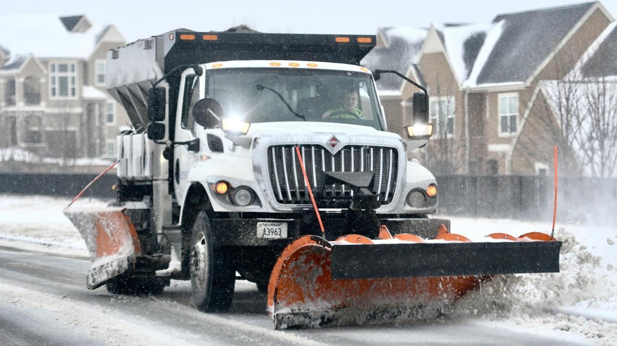 A snowplow clears streets in a neighborhood in Lenexa in 2022.