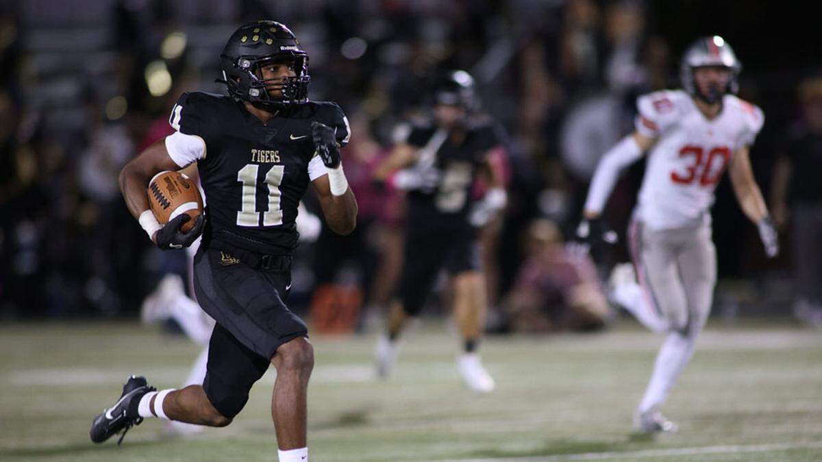 Blue Valley’s Martell Buchanan returns the opening kickoff to spark the Tigers’ 24-20 win over Blue Valley West on Friday night.
