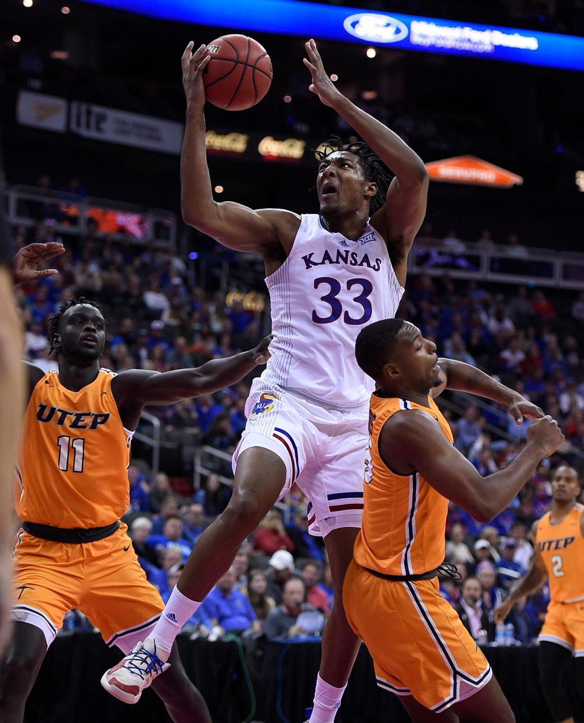 Kansas’ David McCormack powers his way between UTEP’s Bonke Maring (left) and Alfred Hollins on his way to the bucket during the first half of the Jayhawks’ win on Tuesday night at the T-Mobile Center in Kansas City.