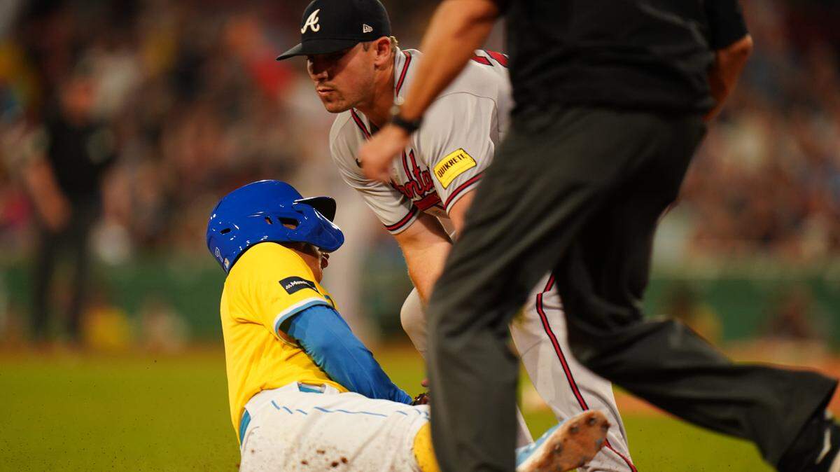 Atlanta Braves third baseman Austin Riley (27) makes the third out of a triple play against the Boston Red Sox in the third inning at Fenway Park.