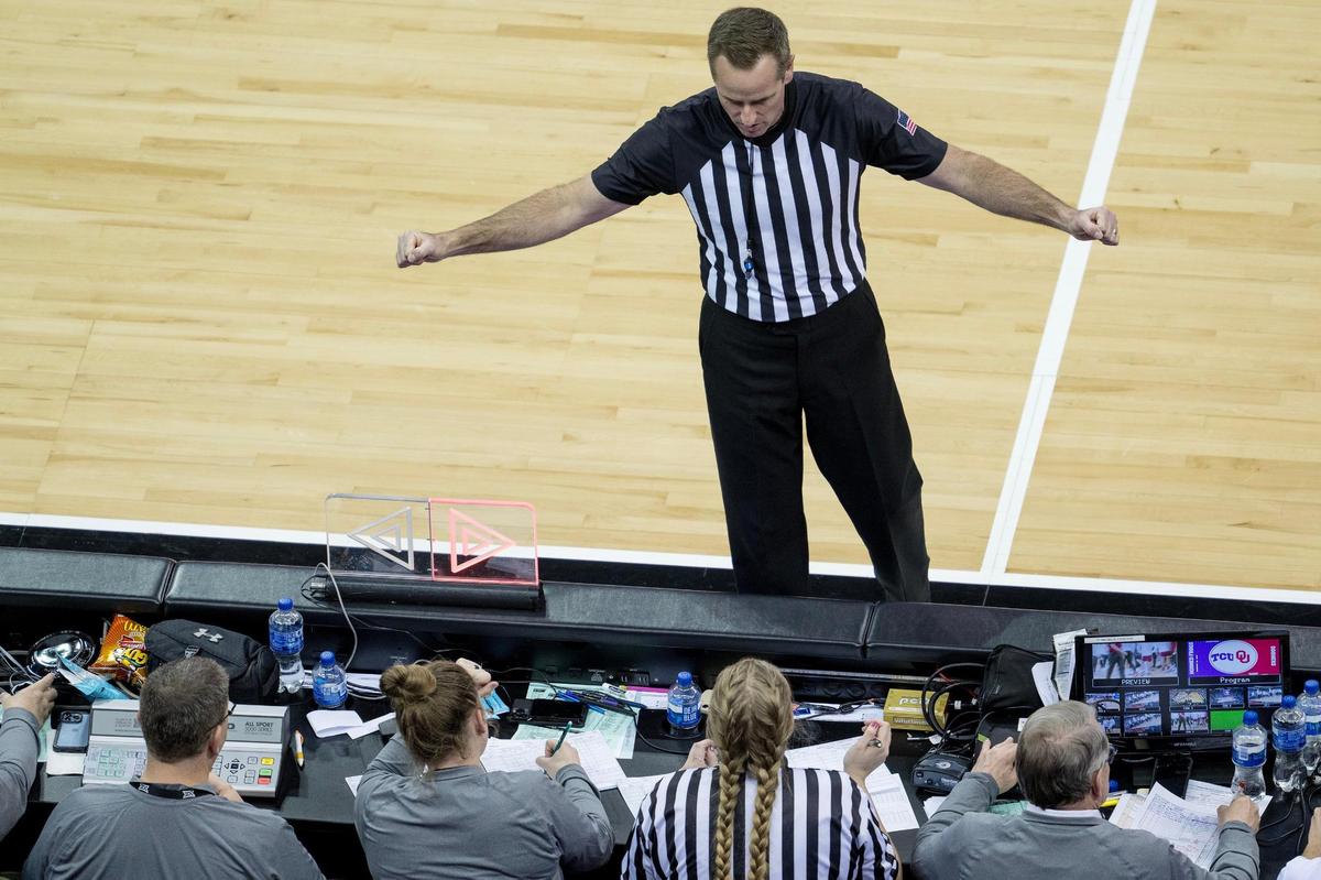The scorer’s table is the nerve center of the games during the Big 12 basketball tournament at T-Mobile Center. Along with the controls for the game clock and scoreboard, there are game staff keeping track of scoring, fouls and other official statistics of each game. An official communicates to the scorer’s table during Wednesday’s second round game between Oklahoma and TCU.