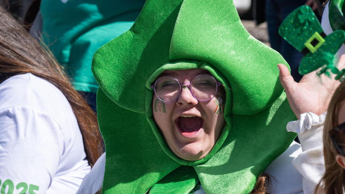 Sabrina Gurdes expresses joy while wearing shamrock in her head during the Kansas City St. Patrick’s Day Parade on Monday, Mar. 17, 2025. Kansas City hosts one of the largest St. Patrick’s Day parades in the country every year.