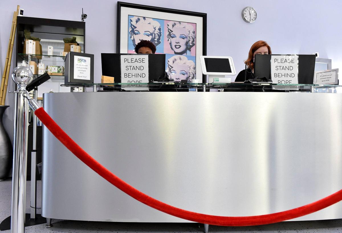 Roca Salon & Spa asks clients to stand behind the rope when they are waiting to check out.