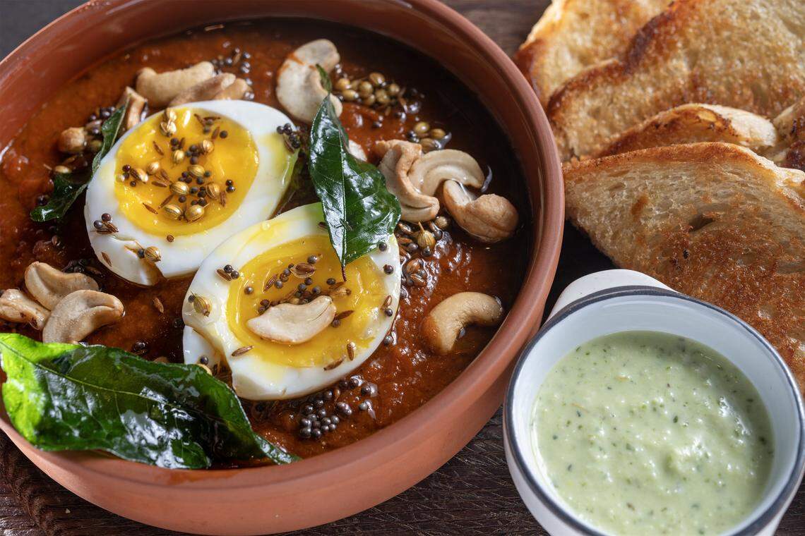 Egg Curry + Toast featuring boiled egg, spicy tomato curry, toasted sourdough, cashew and curry leaf tadka, chili crema is a staple always on the menu at Of Course Kitchen & Co., 7753 W 159th St., in Overland Park on Wednesday, Feb. 25, 2026. 