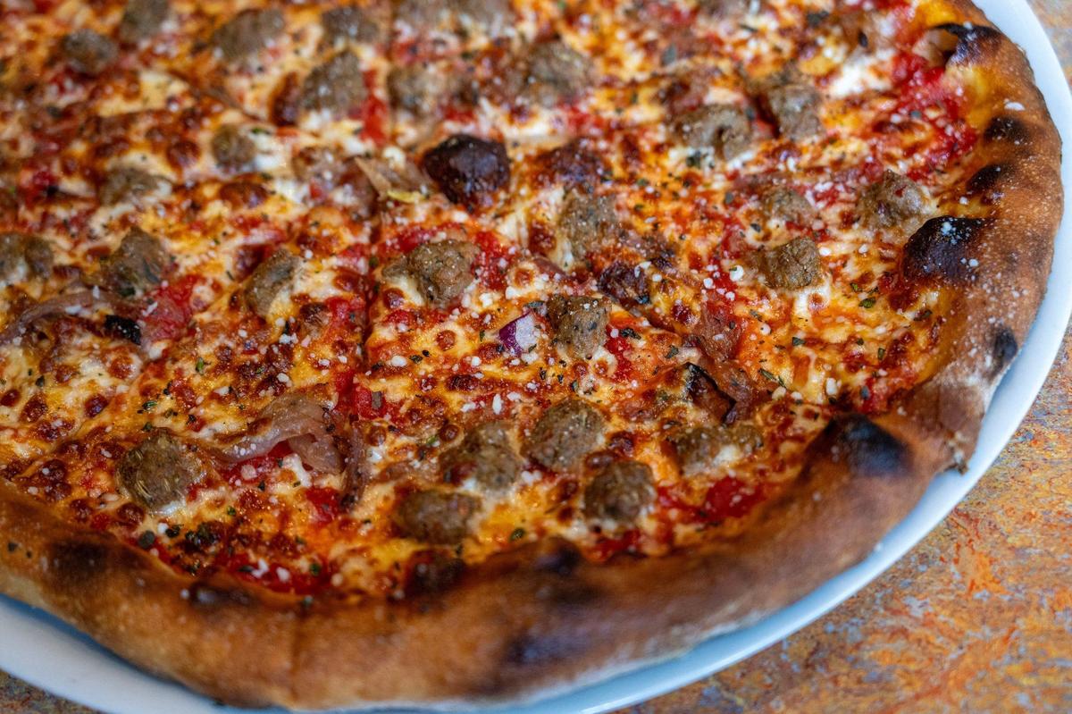 The sausage and caramelized onion pizza is cooked in a fiery stone oven at 550 degrees at Spin! Pizza.