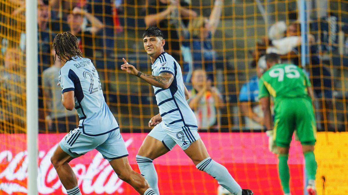 Sporting Kansas City forward Alan Pulido (9) celebrates with defender Zorhan Bassong (22) after scoring a goal in the first half against the Colorado Rapids at Children’s Mercy Park on Sept. 18, 2024.