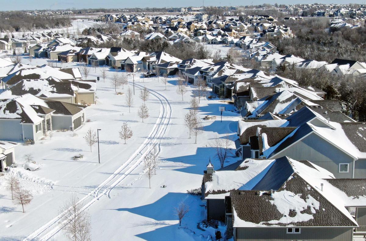 The aftermath of the blizzard could be seen Monday, Jan. 6, 2025, in the Canyon Creek Point neighborhood in west Lenexa. Located off of Wild Rose Lane and Prairie Star Parkway, the area was blanketed in about 11 inches of snow. As of 12:30 p.m. the roads in the neighborhood remained unplowed.