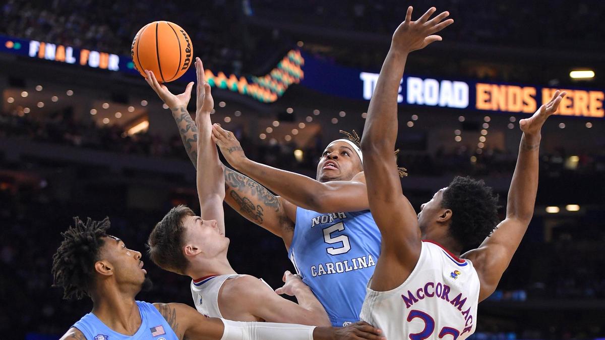 KU’s Christian Braun and David McCormack defend UNC’s Armando Bacot during the first half of Monday night’s NCAA Championship game at the Superdome in New Orleans.