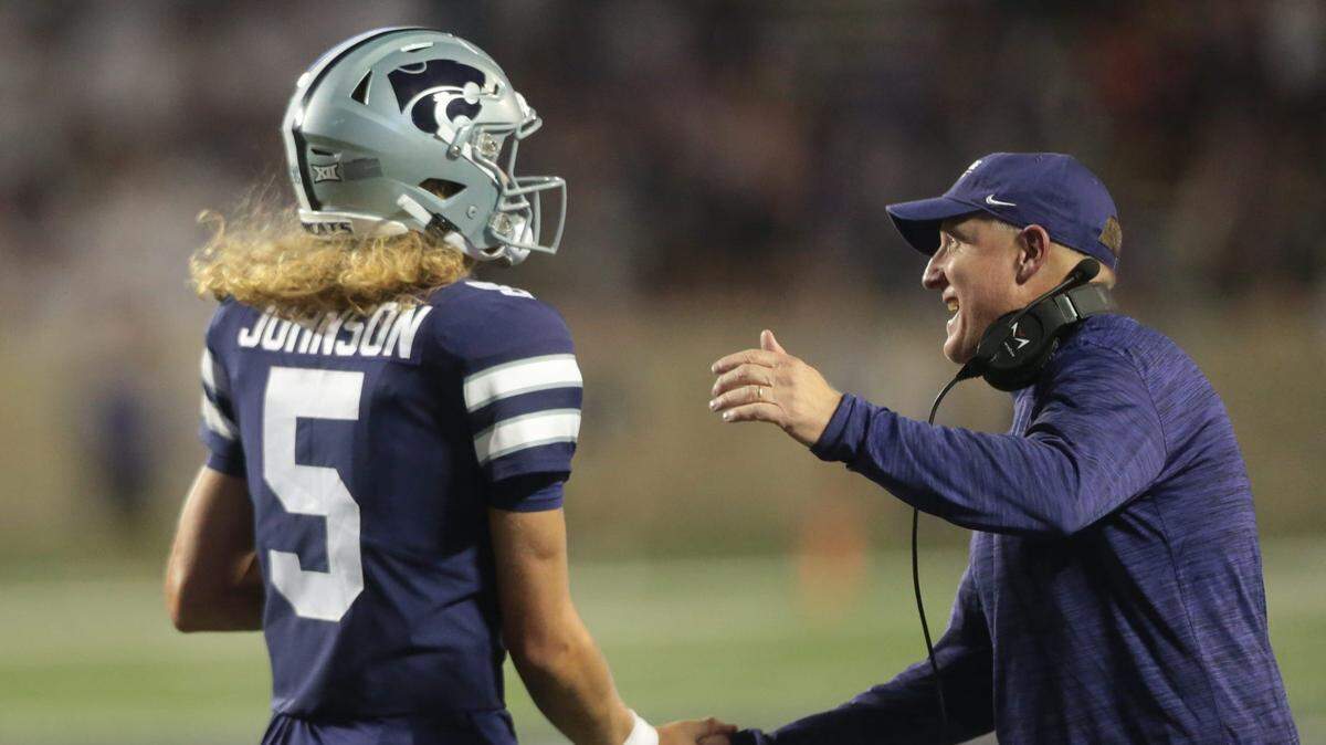 Kansas State freshman quarterback Avery Johnson (5) is applauded by head coach Chris Klieman after a touchdown against SEMO inside Bill Snyder Family Stadium on Sept. 2, 2023.