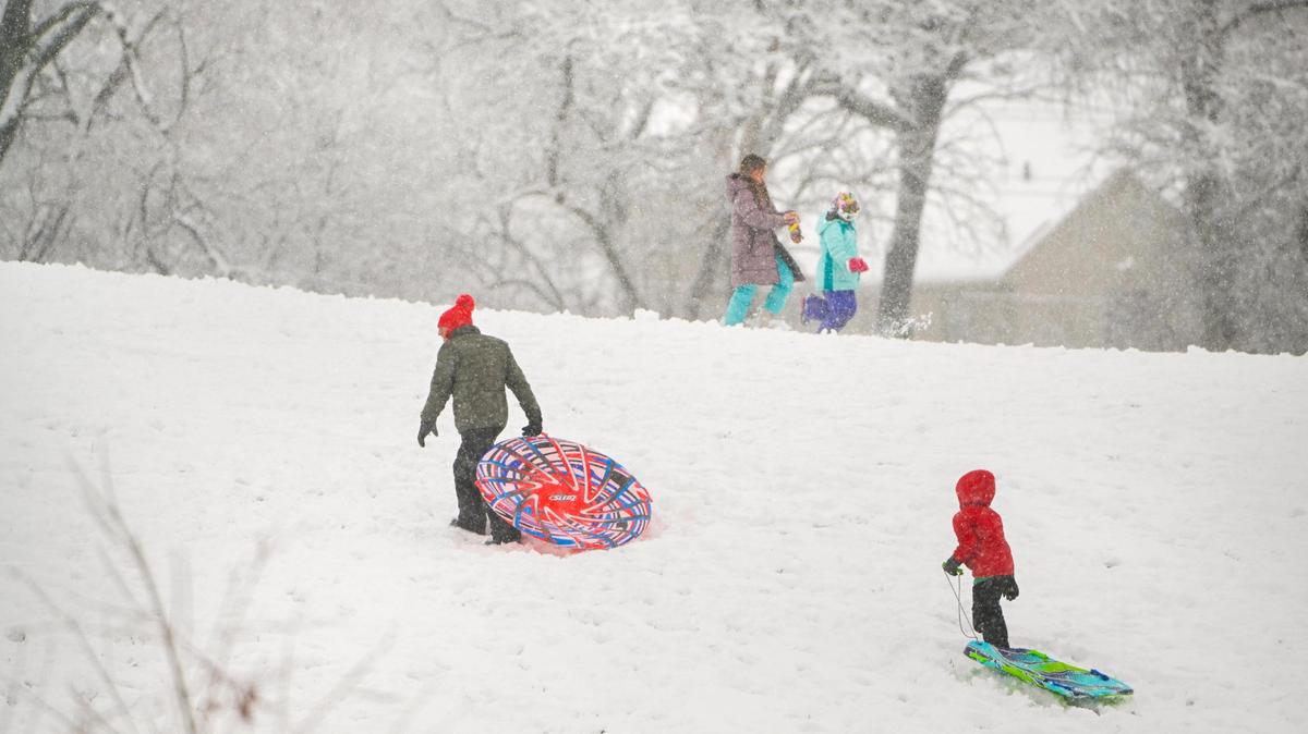 Sledders walked up a hill at Meadowbrook Park on Tuesday, Jan. 9, 2024, which was covered in snow after a winter storm dropped several inches of snow in the metro area including in Prairie Village.