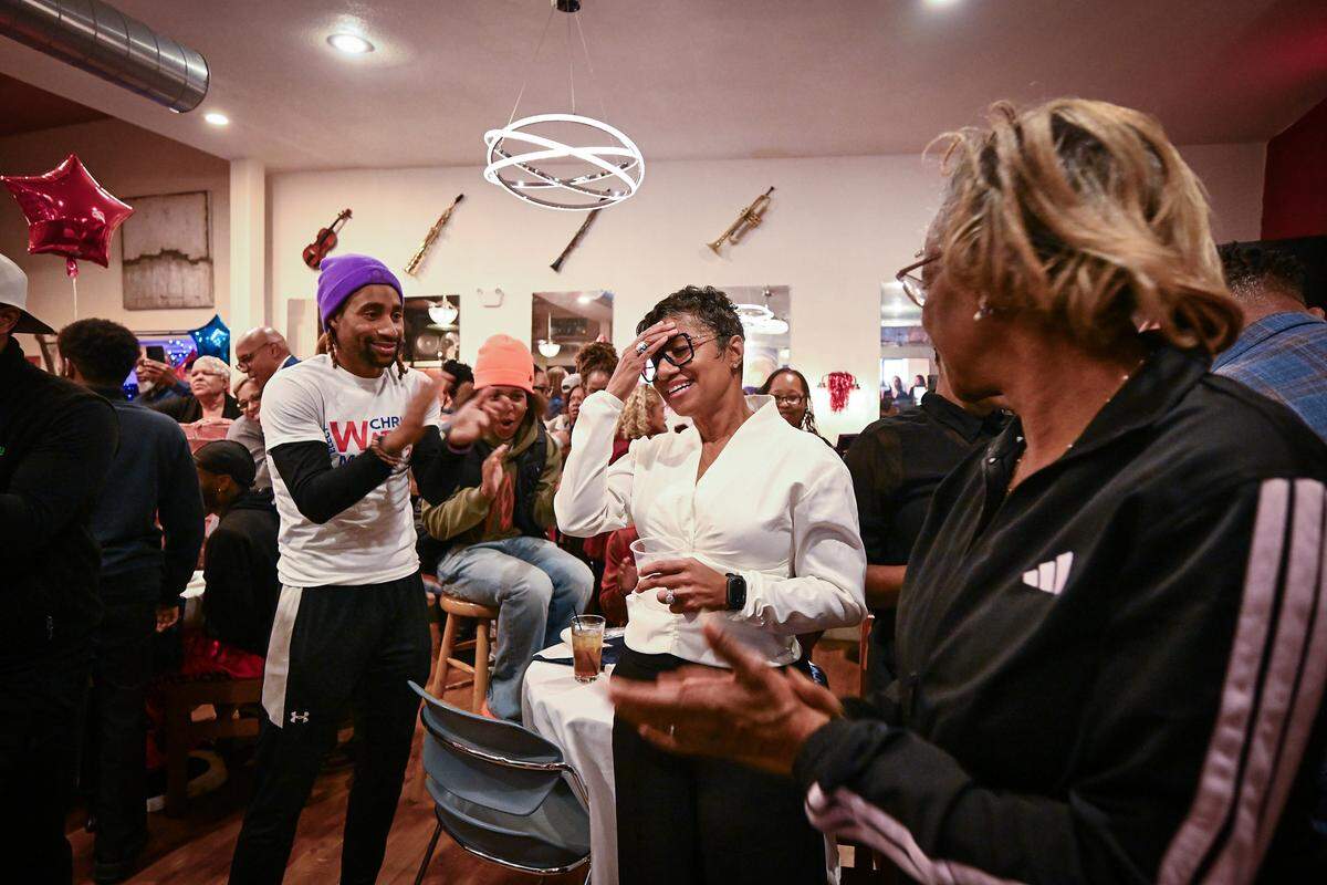 Wyandotte County UG CEO/mayor candidate Christal Watson, center, reacts after seeing election results Tuesday at a watch party at John's Java and Jazz in Kansas City, Kansas.