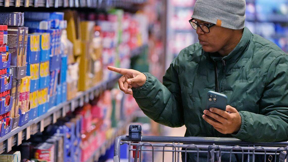 Jontayesha Brown searches through her choices as she grocery shops at the Aldi on Romig Road in Akron, Ohio on Friday Jan. 10, 2025.
