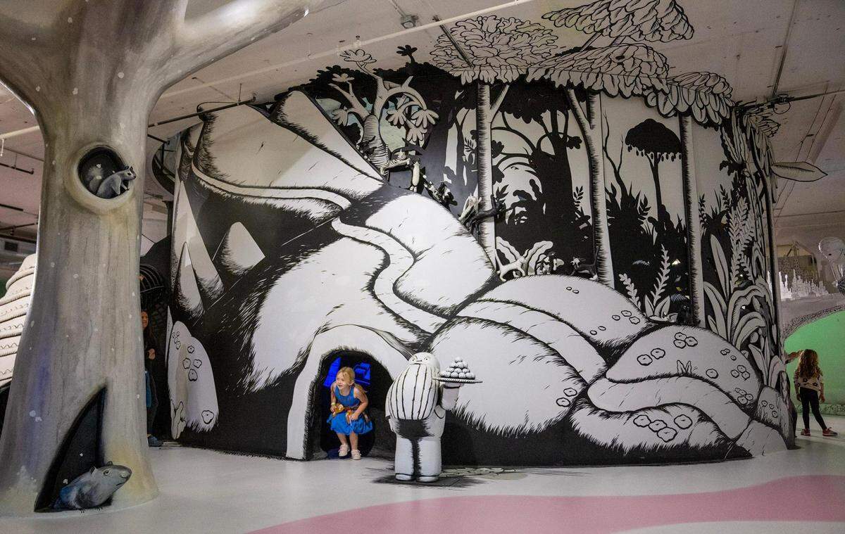 Carolina Mecca, 7, of Liberty emerges from a passageway in the exhibit for “Where the Sidewalk Ends” by Shel Silverstein.
