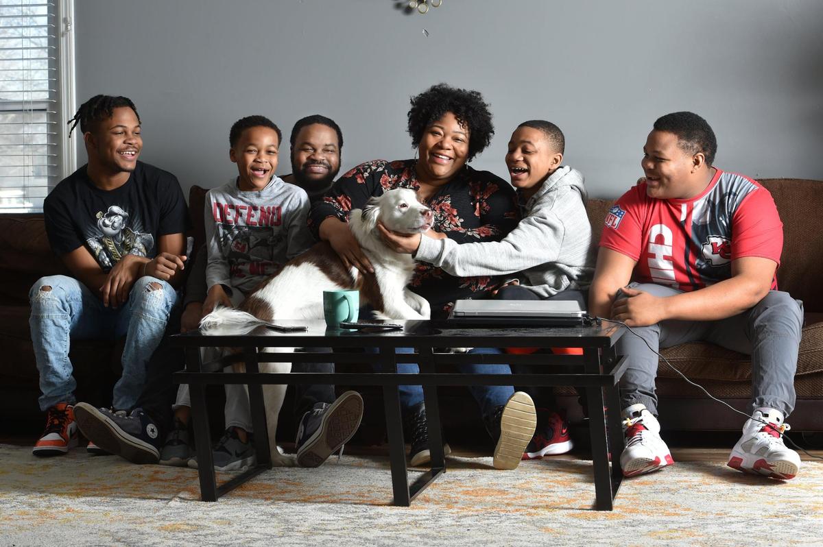 Davoya Marshall, center, with her husband, Brandon Marshall and their four boys, Brandon, 15, from left, Julius, 9 Ezra, 10 and Daniel, 15, right, with their dog, Knox, at their home in Lee’s Summit. The boys attend school in the Lee’s Summit School District and Davoya Marshall is active and vocal at school board meetings.