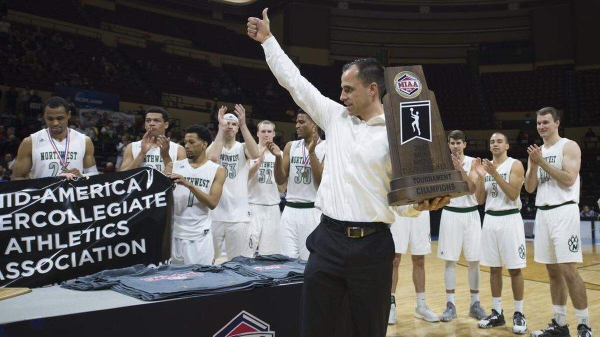 Ben McCollum, men’s basketball coach at Northwest Missouri, gave the crowd a thumbs up while holding the trophy after the Bearcats beat Central Missouri for the MIAA Tournament championship in 2017 at Municipal Auditorium in Kansas City.