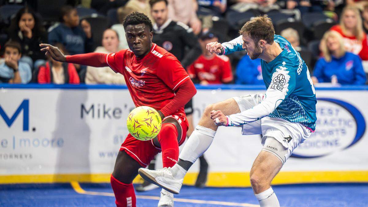 Comets defender Berto Palmer, left, challenges for the ball during a game earlier this season against the St. Louis Ambush.