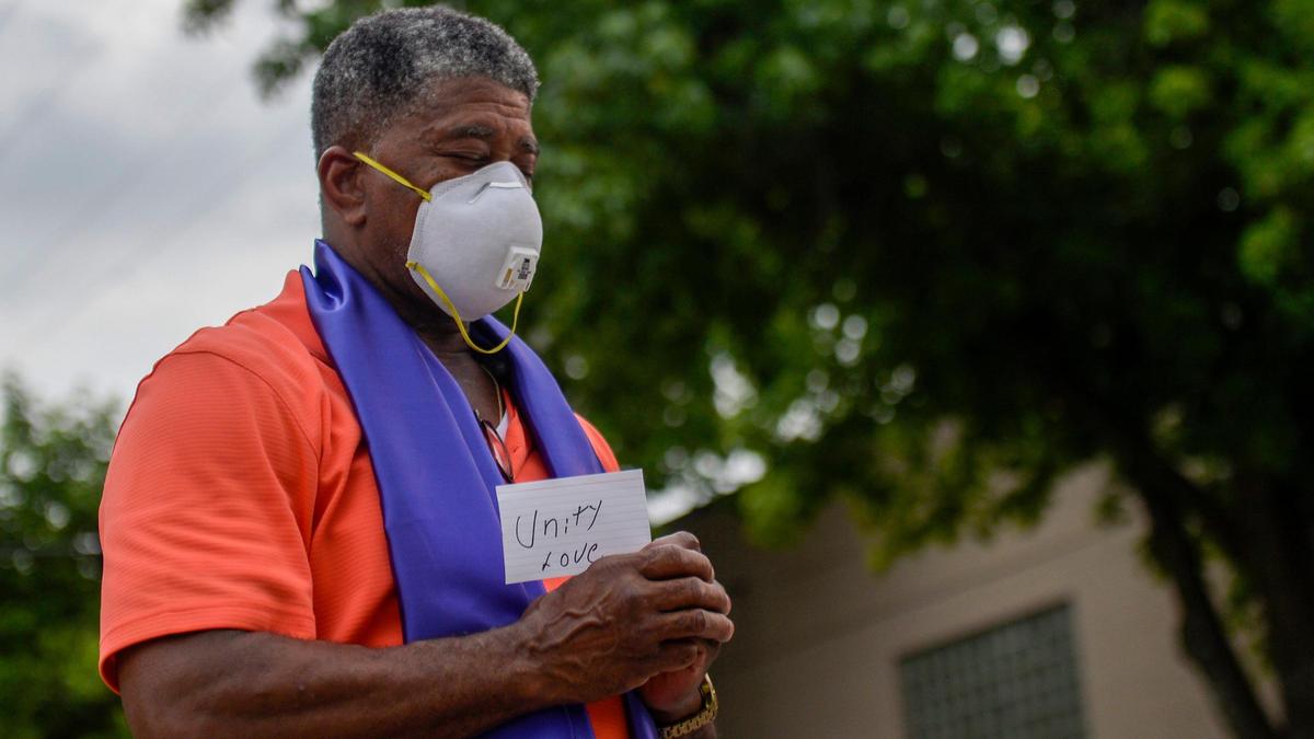 Durrel Campbell, of Kansas City, Missouri, participates in Pray on Troost a peaceful call to prayer addressing racism. Community members gathered on Troost Avenue on Friday, June 19, 2020.