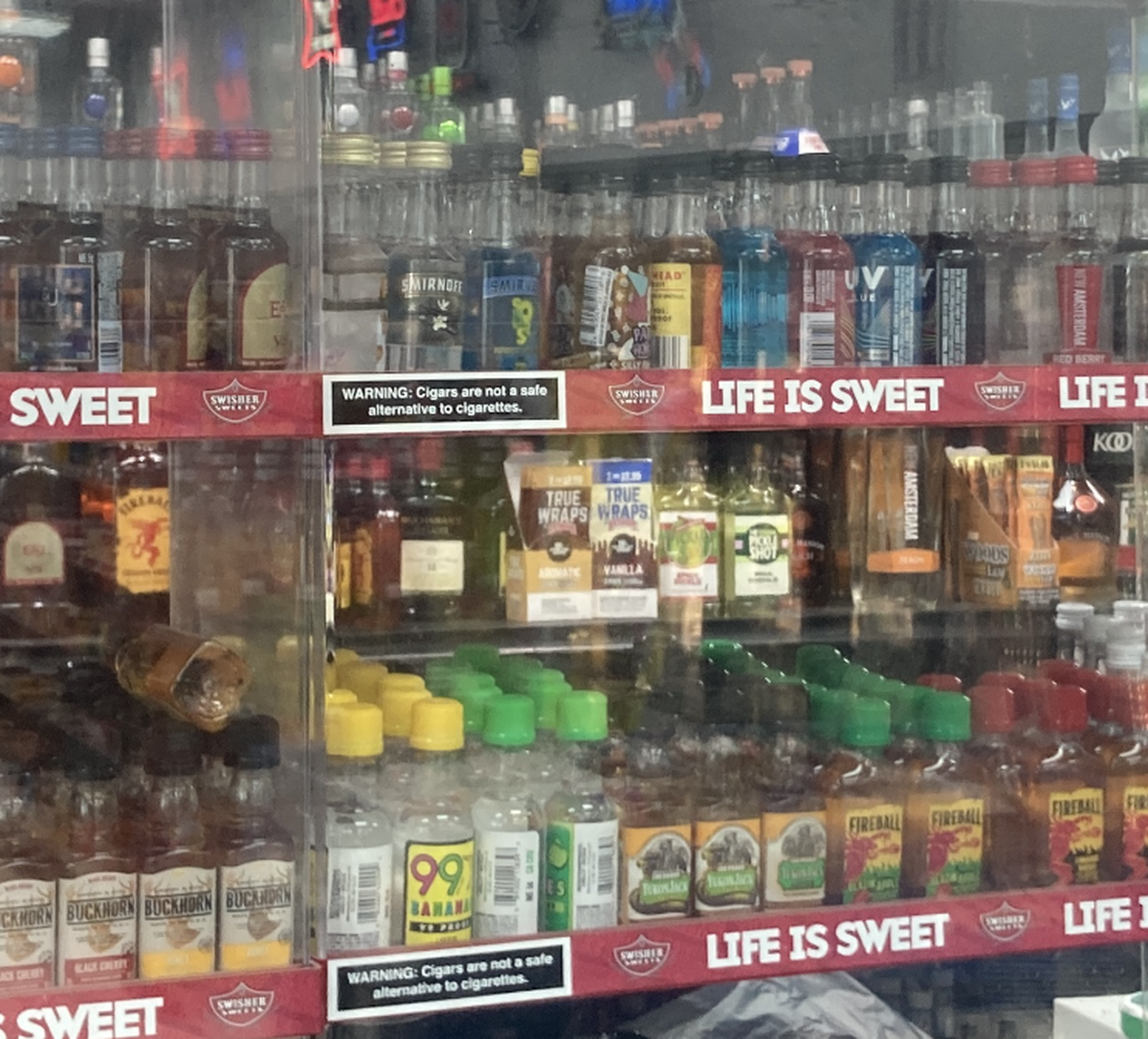 Mini liquor bottles as displayed a liquor store along Prospect Avenue in Kansas City.
