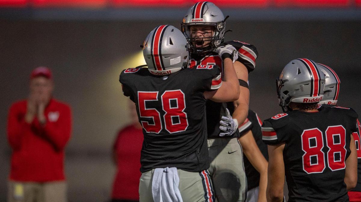 Blue Valley West running back Sage Huffman is lifted by a teammate in celebration after scoring the Jaguars’ third touchdown against the Blue Valley North Mustangs Friday night at Blue Valley West Stadium.