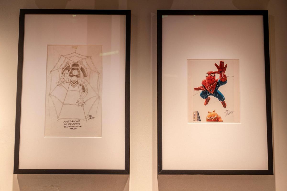 A hand drawn rendering, left, and a photo of a Spider-Man float is seen on display during the “Spider-Man: Beyond Amazing” exhibit set up Monday at Union Station.