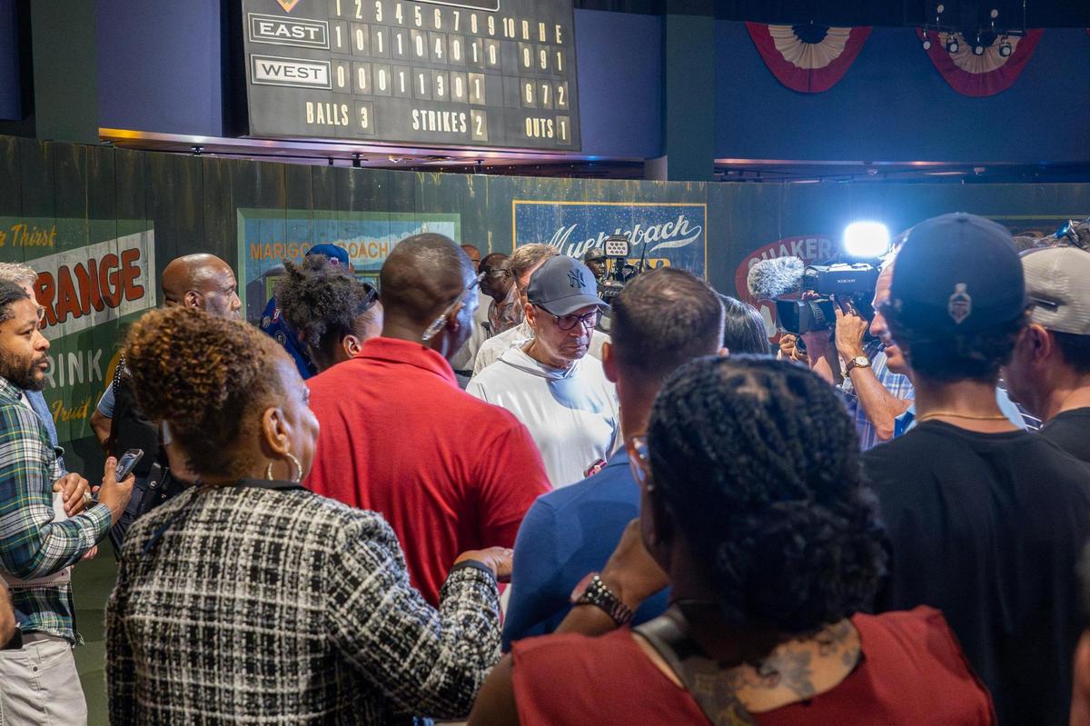 Former New York Yankees right fielder Reggie Jackson, center, is swarmed by reporters seeking comment after a press conference at the Negro Leagues Baseball Museum on Wednesday, June 11, 2025, in Kansas City. The event introduced Jackson as a partner and ambassador for the new Negro Leagues Baseball Museum Hotel.