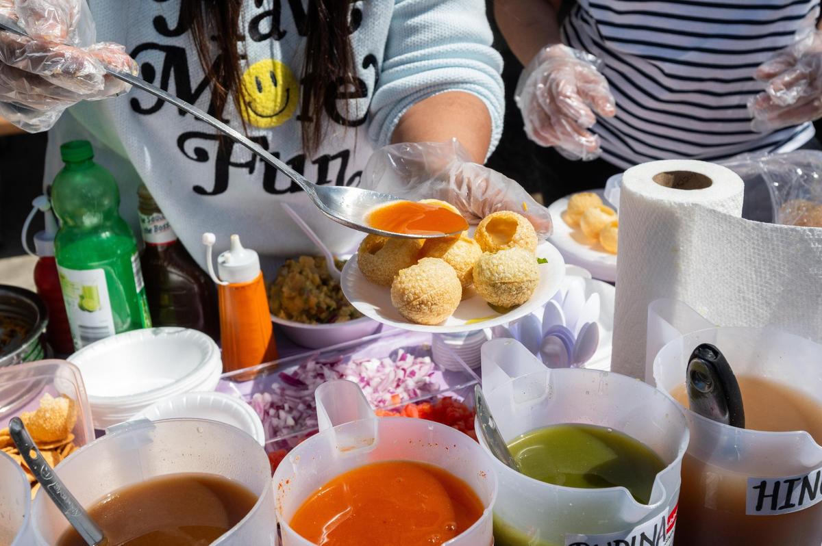 Pani puri, an Indian street food, is served at a Holi Festival of Colors in Overland Park on Sunday.