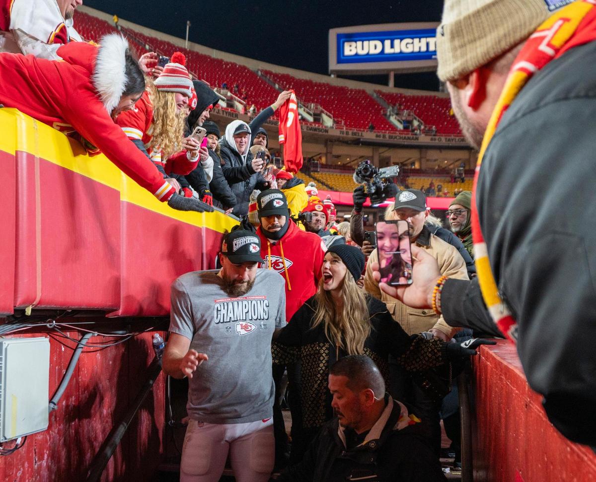 Kansas City Chiefs tight end Travis Kelce (87), left, and Taylor Swift walk off the field after the trophy ceremony following the Chiefs’ 32-29 victory over the Buffalo Bills in the AFC Championship Game on Jan. 26, 2025, at GEHA Field at Arrowhead Stadium.