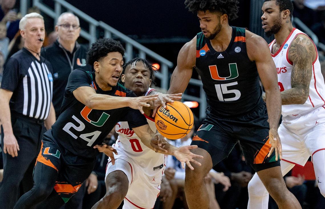Houston guard Marcus Sasser (0) reaches for the ball as Miami guard Nijel Pack (24) rolls off a screen during a Sweet 16 college basketball game in the Midwest Regional of the NCAA Tournament Friday, March 24, 2023, in Kansas City.