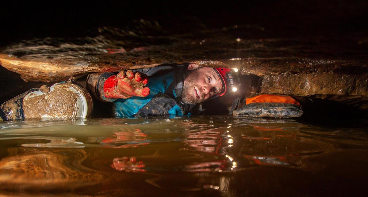 Dan Lamping, president of the Missouri Speleological Survey, a nonprofit cave research group, negotiates a water crawl during a survey project of a Missouri cave. It’s not for the inexperienced.
